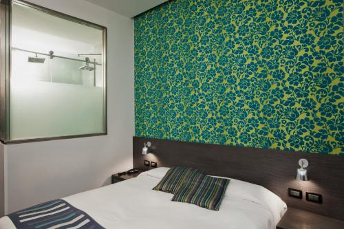 a bedroom with a bed and a green wall at MA Hotel in Santa Margherita Ligure