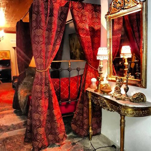 a room with curtains and a mirror and a table at A Hotel Boutique Pelluhue in Pelluhue