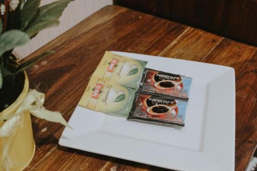 two boxes of donuts sitting on a table at Glory Homestay in Yogyakarta