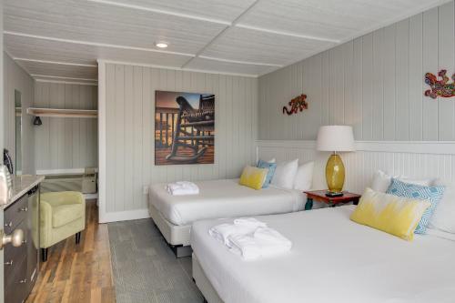 a hotel room with two beds and a desk at See Sea Motel in Kill Devil Hills