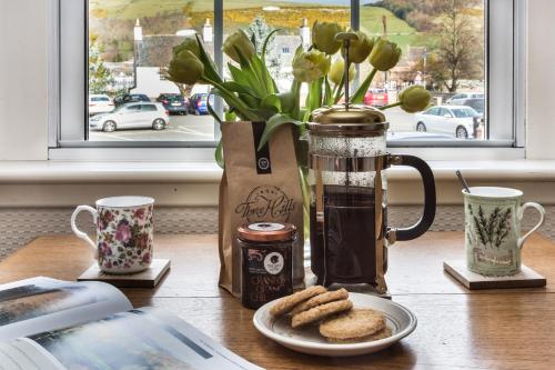 a table with a blender and cookies on a plate at Mabel's View in Melrose