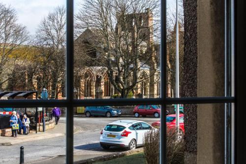 a view from a window of cars parked on a street at Mabel's View in Melrose