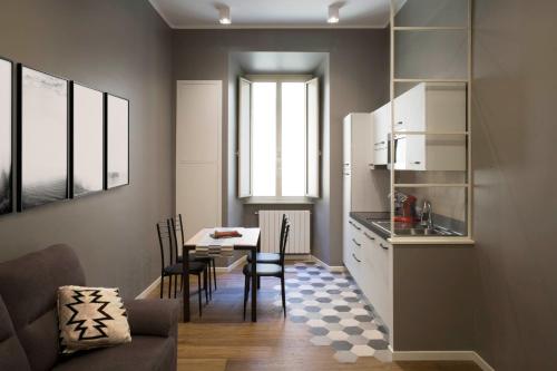 a kitchen and dining room with a table and chairs at Four Elements in Rome
