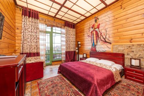 a bedroom with a bed and a painting on the wall at Brech Resort&Spa in Gurinovka Staraya