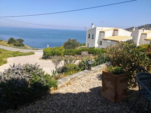 a pathway leading to a house with the ocean in the background at La Vista in Port de la Selva