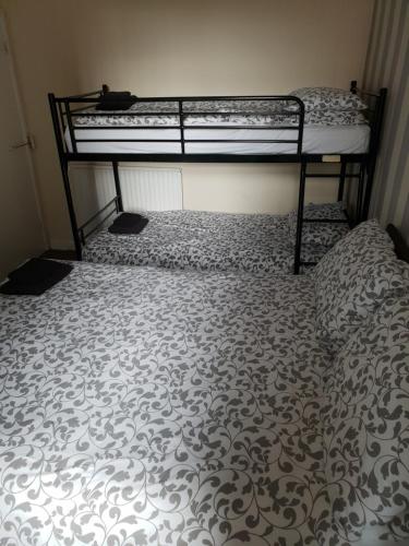 a bedroom with two bunk beds in a room at Langroyd Hotel in Blackpool
