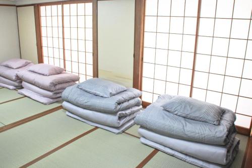 a room with three stacks of pillows on the floor at Beppu Kannawa Onsen HIROMIYA in Beppu