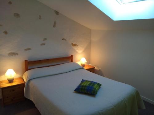 a bedroom with a bed with a pillow on it at Logis de Flamenac in Pranzac