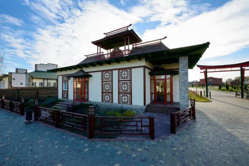 a small building with a balcony on top of it at Brech Resort&Spa in Gurinovka Staraya