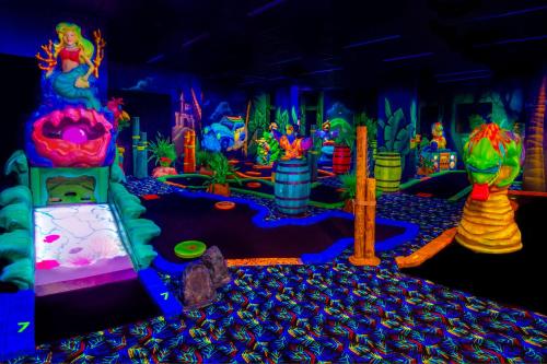 a childrens play room with a play set and a playground at The Grove Resort & Water Park Orlando in Orlando