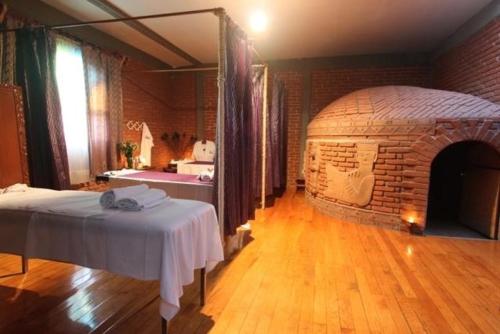 a room with a brick fireplace and a bed in it at Hotel Arcada San Miguel de Allende in San Miguel de Allende
