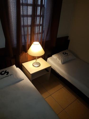 Uma cama ou camas num quarto em Hotel Contorno Sul