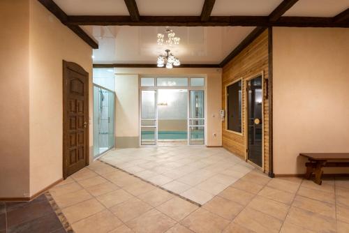 a hallway with doors and a tile floor at Brech Resort&Spa in Gurinovka Staraya