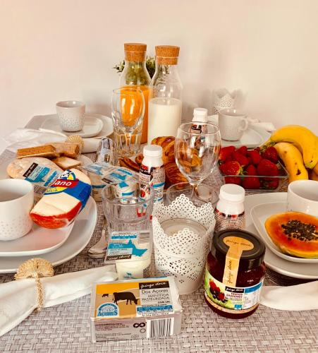 a table with plates of food and bottles of milk at Apartments Alfacinha Ajuda in Lisbon