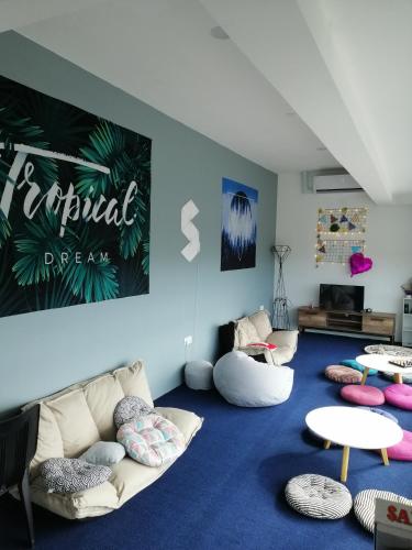 a living room with a couch and some tables at Space Cap Hotel in Kota Kinabalu