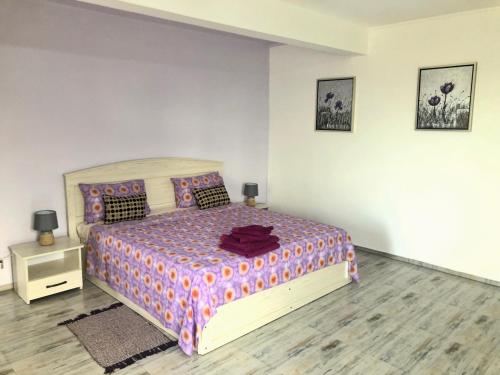 a bedroom with a large bed and a night stand at Villa Annjo in Pointe aux Piments