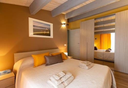 a bedroom with a large bed with towels on it at Il Sopracciglio Suites - Green Suite in Cassino