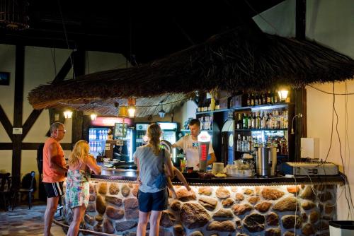 a group of people standing at a bar at Kietlice nad Mamrami in Węgorzewo