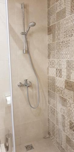 a shower with a shower head in a bathroom at Apartment GEA 24 Zlatibor sa garažom in Zlatibor