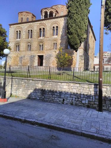 an old stone building with a fence in front of it at Maisonette Ilios in Plisioí