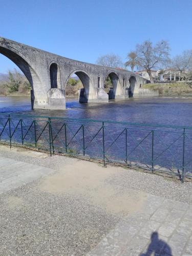a bridge over a river next to a body of water at Maisonette Ilios in Plisioí
