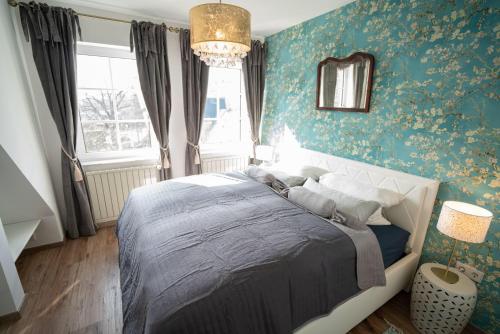 a bedroom with a bed and a chandelier at Villa Golding - Flat 3 in Dresden