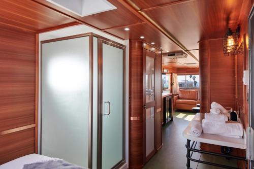 a small room with a bed and a glass door at Waypoint Ventura in Ventura