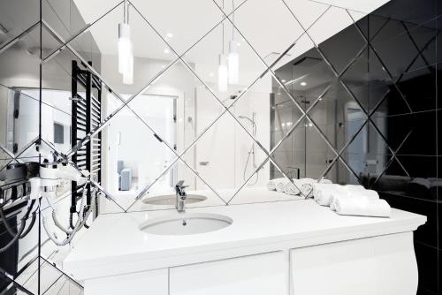 a bathroom with a sink and a mirror at Mielno Dune B Apartamenty in Mielno