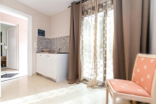 un salon avec une chaise et une fenêtre dans l'établissement GREEN and BLUE VILLA, à Glykadi