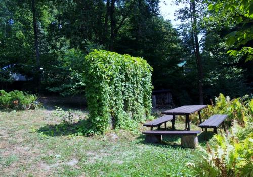 a picnic table and benches in a park at chata Milena in Český Dub