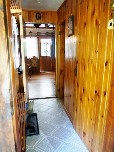 a hallway of a house with wooden walls at chata Milena in Český Dub