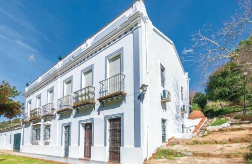 a white building with balconies on the side of it at Finca San Juan Alojamiento Boutique in Constantina