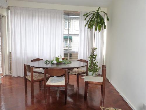 ブエノスアイレスにあるAlto Palermo, ,espacio y luzのダイニングルーム(テーブル、椅子、植物付)