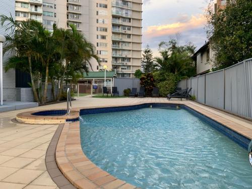 a swimming pool in the middle of a building at Burleigh Gardens North Hi-Rise Holiday Apartments in Gold Coast