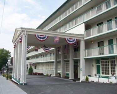 a large building with american flags on it at 1863 Inn of Gettysburg in Gettysburg