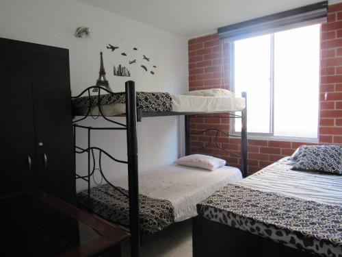 a room with two bunk beds and a window at Reservas del peñon in Girardot