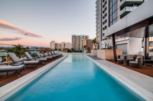 a swimming pool on the roof of a building at Iconic Kirra Beach Resort in Gold Coast