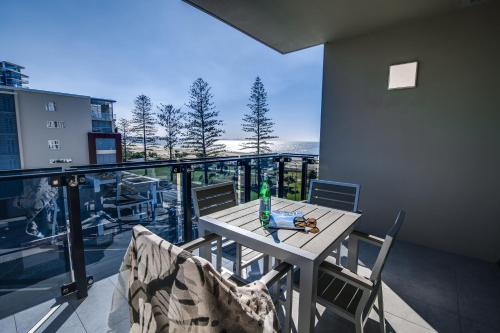 a table and chairs on a balcony with a view at Iconic Kirra Beach Resort in Gold Coast