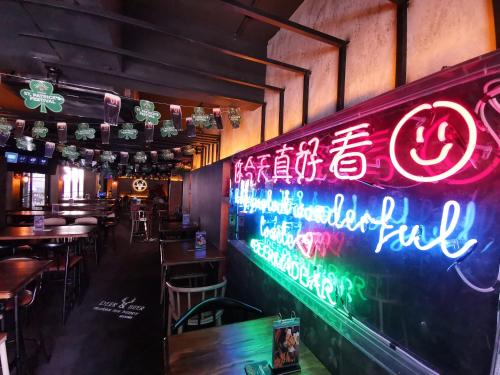a restaurant with a neon sign on the wall at The Core Hotel in Subang Jaya
