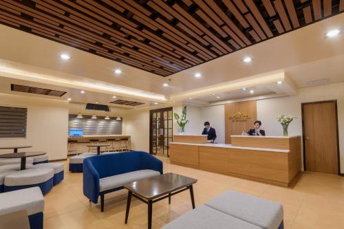 a waiting room at a hospital with two people in the waiting room at Microtel by Wyndham Davao in Davao City