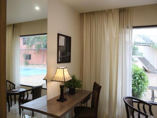a dining room with a table and a window at Seven Sky Clarks Exotica in Bhuj