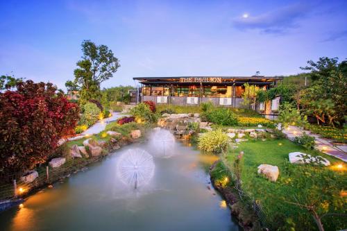 an aerial view of a building with a river at The Private Pool Villas at Civilai Hill Khao Yai in Nong Sarai