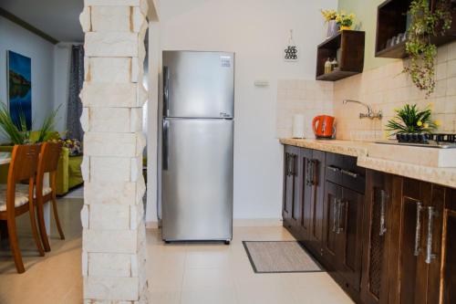 a kitchen with a stainless steel refrigerator at מטיילים בגליל העליון in Qiryat Shemona