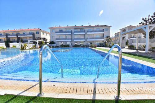 a swimming pool in front of a building at Limegrove Holiday Apartment in Protaras