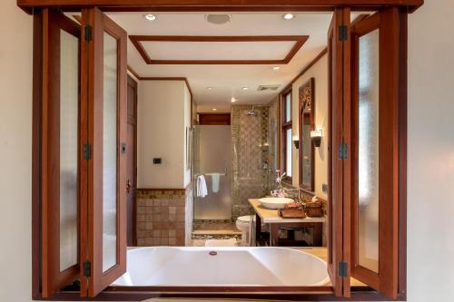 a bathroom with a sink and a bath tub at Ariyasom Villa - SHA Extra Plus in Bangkok