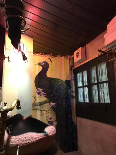 a bathroom with a bird painted on the wall at 安平老街四君閣 Sijunge Anping B&B in Anping