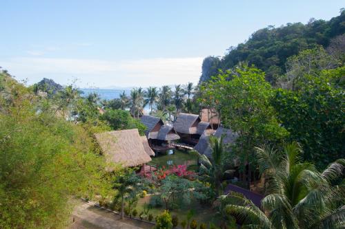 an aerial view of a resort with trees and the ocean at Cauayan Island Resort and Spa in El Nido