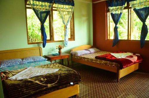 מיטה או מיטות בחדר ב-VAMOOSE PARKHA SIKKIM