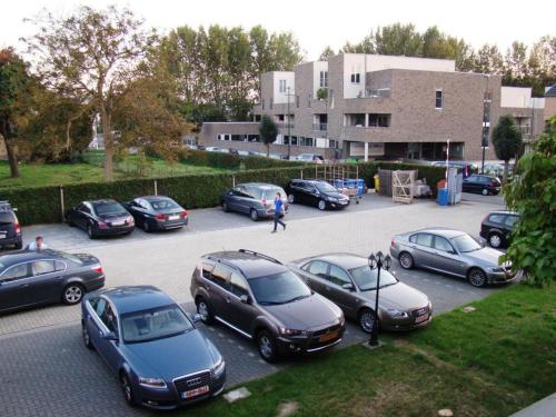 a bunch of cars parked in a parking lot at Hotel Taormina Brussels Airport in Zaventem