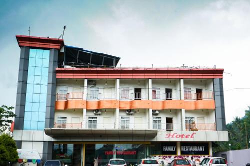 a hotel with cars parked in front of it at MGS Residency in Kallar Vattiyar